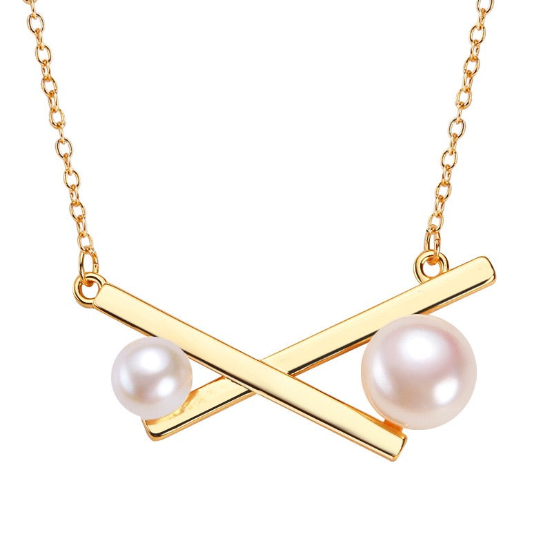 A brass plated necklace 2024 with cultured pearls.